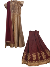 Gold and maroon traditional outfit with embroidered details on a white background